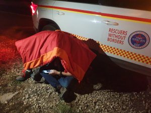 Rescuers Protected Under a Protective Shield